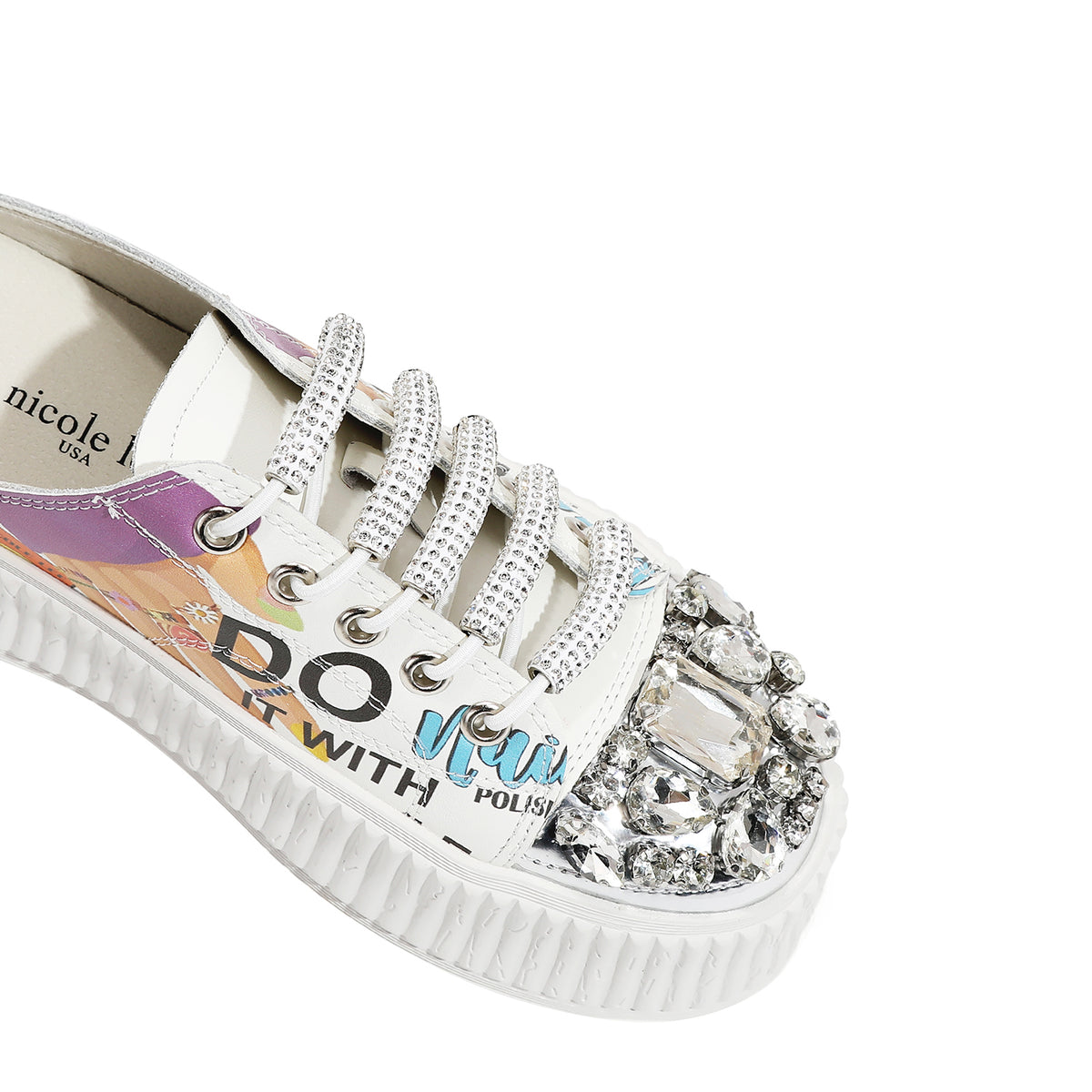 A CLOSER LOOK TO THE FRONT OF OUR NAIL POLISH MULE PLATFORM SNEAKERS. WHITE COLOR WITH WHITE LACES EMBELLISHED WITH RHINESTONES .