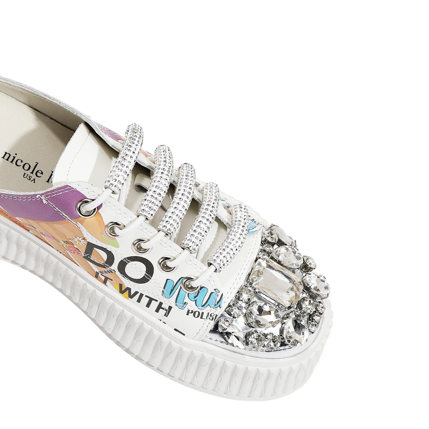 A CLOSER LOOK TO THE FRONT OF OUR NAIL POLISH MULE PLATFORM SNEAKERS. WHITE COLOR WITH WHITE LACES EMBELLISHED WITH RHINESTONES .