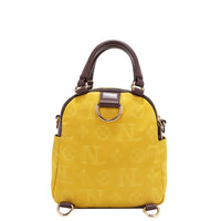 OUR NICOLE LEE MARGOT MULTI-WEAR DOME BAG IN YELLOW. THE BACK HAS D-RINGS FOR BACKPACK OR CROSSBODY WEAR.