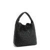 Back angle of Juni handbag crafted in braided vegan leather in classic, timeless black with a top handle (5" drop) and open slip compartment secured with a magnetic snap closure. Slouchy, relaxed silhouette offers a chic and laid-back yet refined look.
