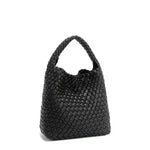 Back angle of Juni handbag crafted in braided vegan leather in classic, timeless black with a top handle (5" drop) and open slip compartment secured with a magnetic snap closure. Slouchy, relaxed silhouette offers a chic and laid-back yet refined look.