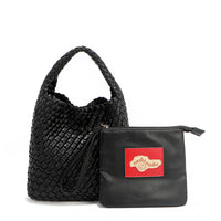 Soft, slouchy, and effortlessly chic—meet Juni from Nodu Nadu by Nicole Lee. Crafted from braided vegan leather, this beauty boasts a relaxed silhouette, a bonus zip pouch inside, and an optional matching strap. The ultimate go-anywhere, carry-everything statement piece—style it your way, every day! Available in a classic, timeless black shade along with even more versatile and on-trend tones to express your unique style. Each Juni bag comes with its own removable zip pouch in a solid matching color.