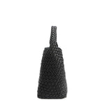 Side silhouette of Juni handbag crafted in braided vegan leather in classic, timeless black with a top handle (5" drop). Slouchy, relaxed silhouette offers a chic and laid-back yet refined look.
