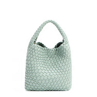 Juni handbag crafted in braided vegan leather in pastel, dusty blue with a top handle (5" drop) and open slip compartment secured with a magnetic snap closure. Slouchy, relaxed silhouette offers a chic and laid-back yet refined look.
