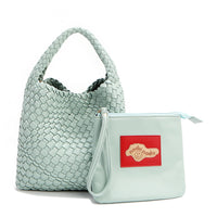 Soft, slouchy, and effortlessly chic—meet Juni from Nodu Nadu by Nicole Lee. Crafted from braided vegan leather, this beauty boasts a relaxed silhouette, a bonus zip pouch inside, and an optional matching strap. The ultimate go-anywhere, carry-everything statement piece—style it your way, every day! Available in a pastel, dusty blue shade along with even more versatile and on-trend tones to express your unique style. Each Juni bag comes with its own removable zip pouch in a solid matching color.