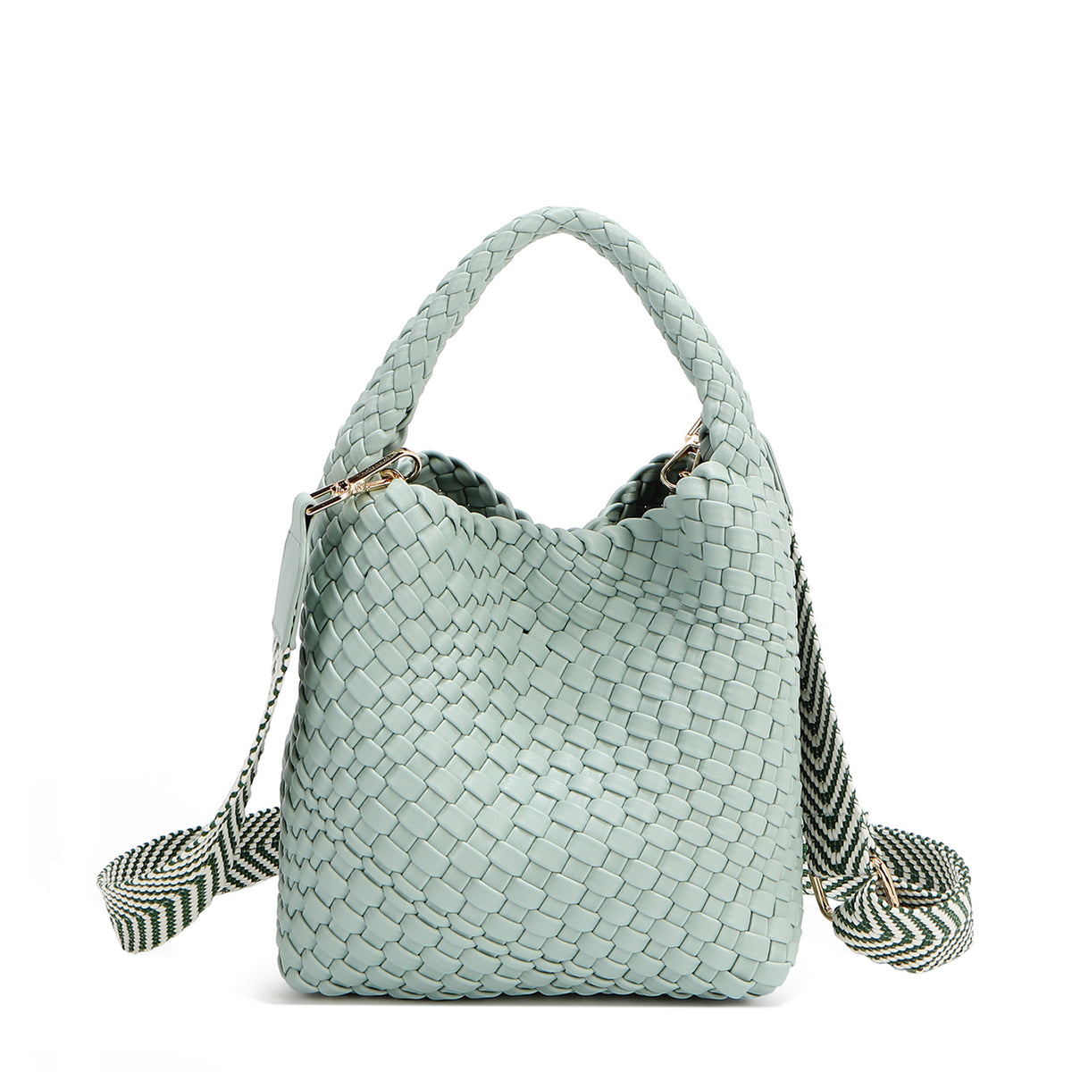 Introducing Juni from Nodu Nadu by Nicole Lee, a versatile and slouchy chic handbag with a removable pouch inside. Crafted in braided vegan leather with an optional, adjustable chevron striped shoulder strap for varied carrying options so you can wear it across the body or by the top handle for a sleek look. Pictured in a pastel, dusty blue shade with a tonal striped shoulder strap.