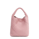 Back of Juni handbag crafted in braided vegan leather in pastel, dusty pink with a top handle (5" drop) and open slip compartment secured with a magnetic snap closure. Slouchy, relaxed silhouette offers a chic and laid-back yet refined look.