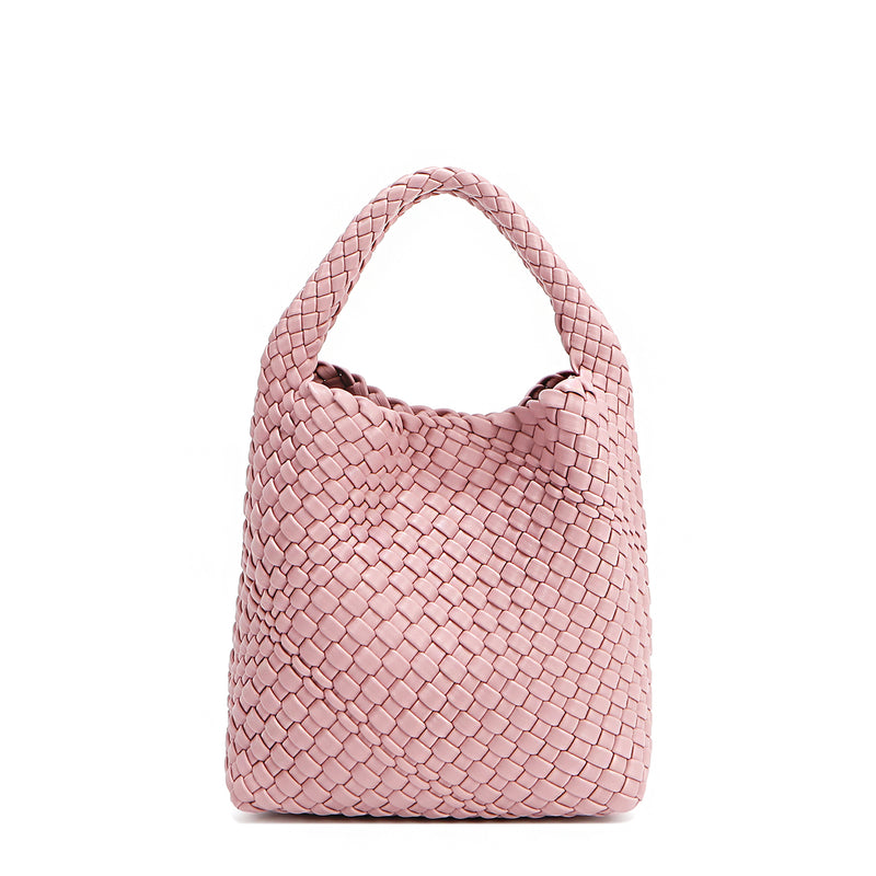 Back of Juni handbag crafted in braided vegan leather in pastel, dusty pink with a top handle (5" drop) and open slip compartment secured with a magnetic snap closure. Slouchy, relaxed silhouette offers a chic and laid-back yet refined look.