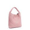 Front angle of Juni handbag crafted in braided vegan leather in pastel, dusty pink with a top handle (5" drop) and open slip compartment secured with a magnetic snap closure. Slouchy, relaxed silhouette offers a chic and laid-back yet refined look.