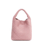 Juni handbag crafted in braided vegan leather in pastel, dusty pink with a top handle (5" drop) and open slip compartment secured with a magnetic snap closure. Slouchy, relaxed silhouette offers a chic and laid-back yet refined look.
