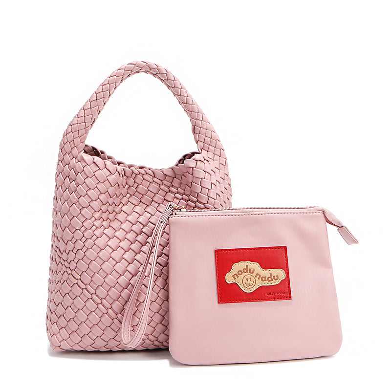 Soft, slouchy, and effortlessly chic—meet Juni from Nodu Nadu by Nicole Lee. Crafted from braided vegan leather, this beauty boasts a relaxed silhouette, a bonus zip pouch inside, and an optional matching strap. The ultimate go-anywhere, carry-everything statement piece—style it your way, every day! Available in a pastel, dusty pink shade along with even more versatile and on-trend tones to express your unique style. Each Juni bag comes with its own removable zip pouch in a solid matching color.