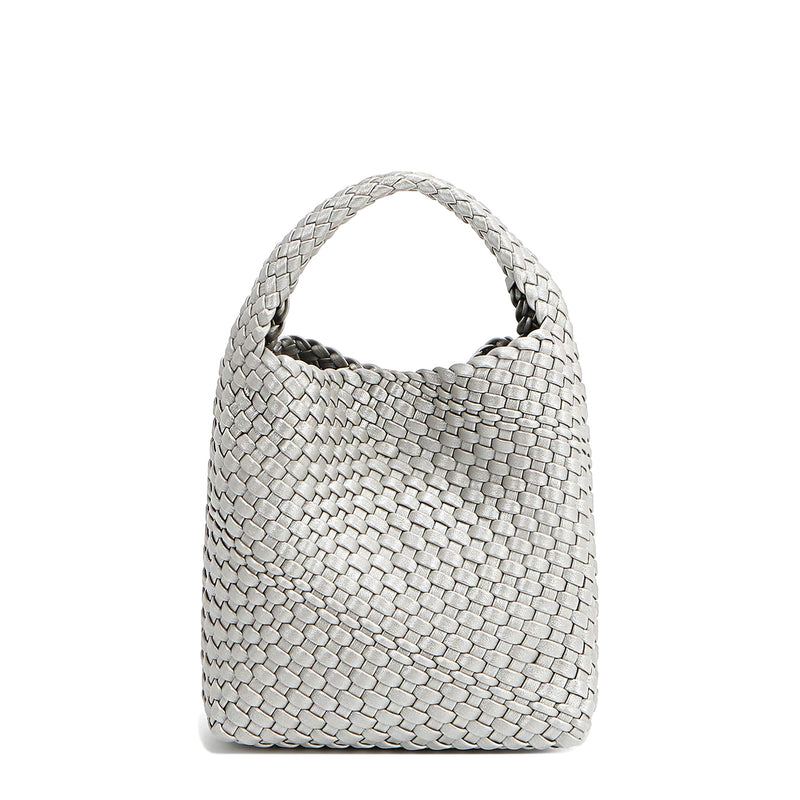 Back of Juni handbag crafted in braided vegan leather in metallic silver with a top handle (5" drop) and open slip compartment secured with a magnetic snap closure. Slouchy, relaxed silhouette offers a chic and laid-back yet refined look.