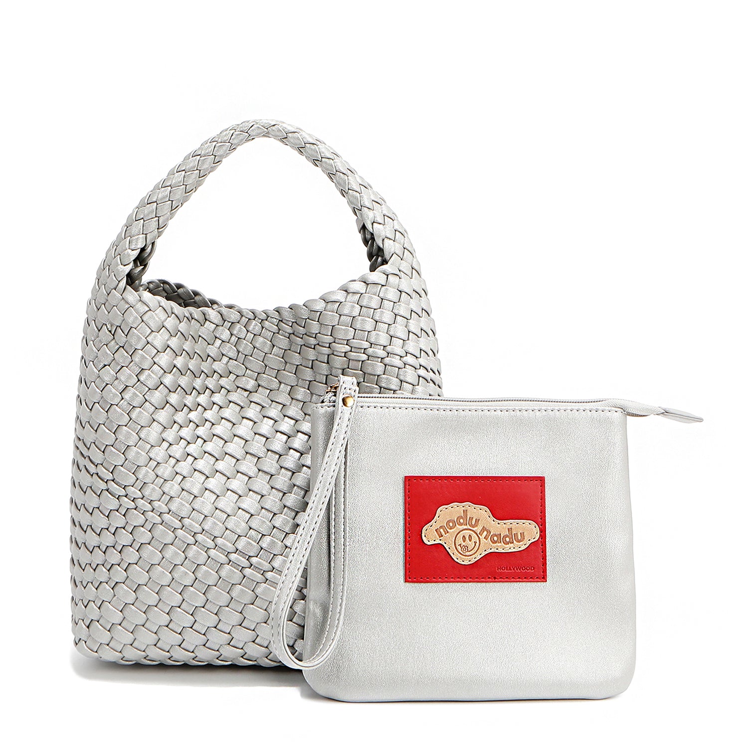 Soft, slouchy, and effortlessly chic—meet Juni from Nodu Nadu by Nicole Lee. Crafted from braided vegan leather, this beauty boasts a relaxed silhouette, a bonus zip pouch inside, and an optional matching strap. The ultimate go-anywhere, carry-everything statement piece—style it your way, every day! Available in a metallic silver shade along with even more versatile and on-trend tones to express your unique style. Each Juni bag comes with its own removable zip pouch in a solid matching color.