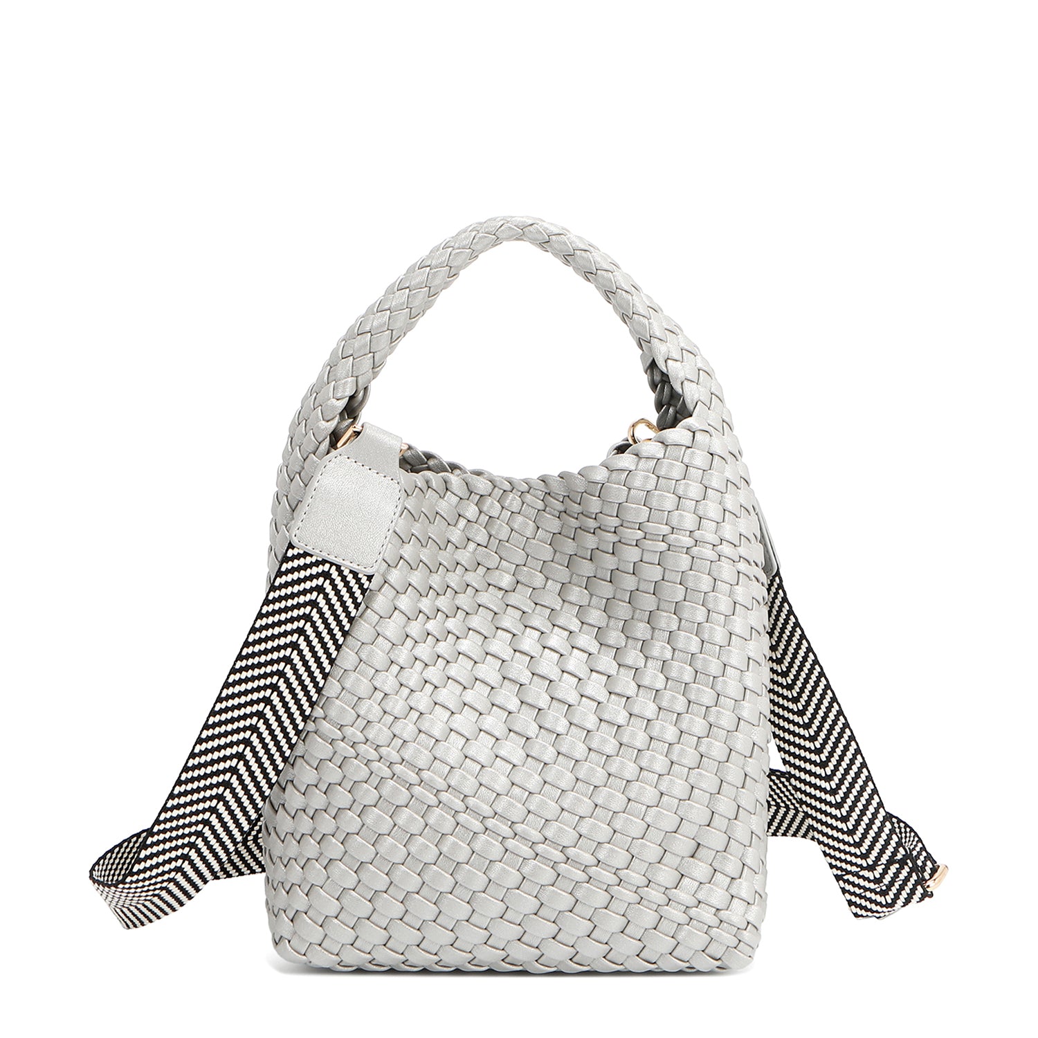 Introducing Juni from Nodu Nadu by Nicole Lee, a versatile and slouchy chic handbag with a removable pouch inside. Crafted in braided vegan leather with an optional, adjustable chevron striped shoulder strap for varied carrying options so you can wear it across the body or by the top handle for a sleek look. Pictured in a silver, metallic shade with a black and white striped shoulder strap.