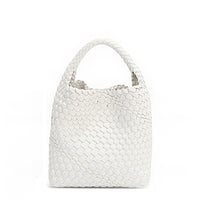 Back of Juni handbag crafted in braided vegan leather in classic, timeless white with a top handle (5" drop) and open slip compartment secured with a magnetic snap closure. Slouchy, relaxed silhouette offers a chic and laid-back yet refined look.