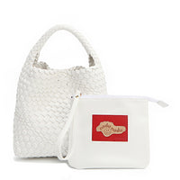 Soft, slouchy, and effortlessly chic—meet Juni from Nodu Nadu by Nicole Lee. Crafted from braided vegan leather, this beauty boasts a relaxed silhouette, a bonus zip pouch inside, and an optional matching strap. The ultimate go-anywhere, carry-everything statement piece—style it your way, every day! Available in a classic, timeless white shade along with even more versatile and on-trend tones to express your unique style. Each Juni bag comes with its own removable zip pouch in a solid matching color.