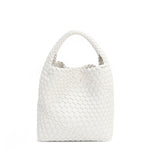 Juni handbag crafted in braided vegan leather in classic, timeless white with a top handle (5" drop) and open slip compartment secured with a magnetic snap closure. Slouchy, relaxed silhouette offers a chic and laid-back yet refined look.
