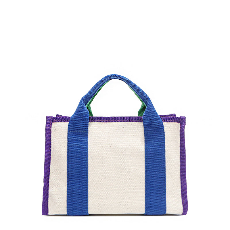 Back of the Rowan bag by Nodu Nadu by Nicole Lee. A bold mix of colors like vivid green, electric blue and vibrant purple trim evoke a sense of fun and lots of personality to mix and match your style. Dual top handles with a 3" drop allow you to carry this statement bag by the top handles. Pictured in classic beige that compliments any look, regardless of the season. 