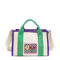 The Rowan bag by Nodu Nadu by Nicole Lee. A bold mix of colors like vivid green, electric blue and vibrant purple trim evoke a sense of fun and lots of personality to mix and match your style. Dual top handles with a 3" drop allow you to carry this statement bag by the top handles or wear it across the body thanks to the optional, adjustable beige shoulder strap! 