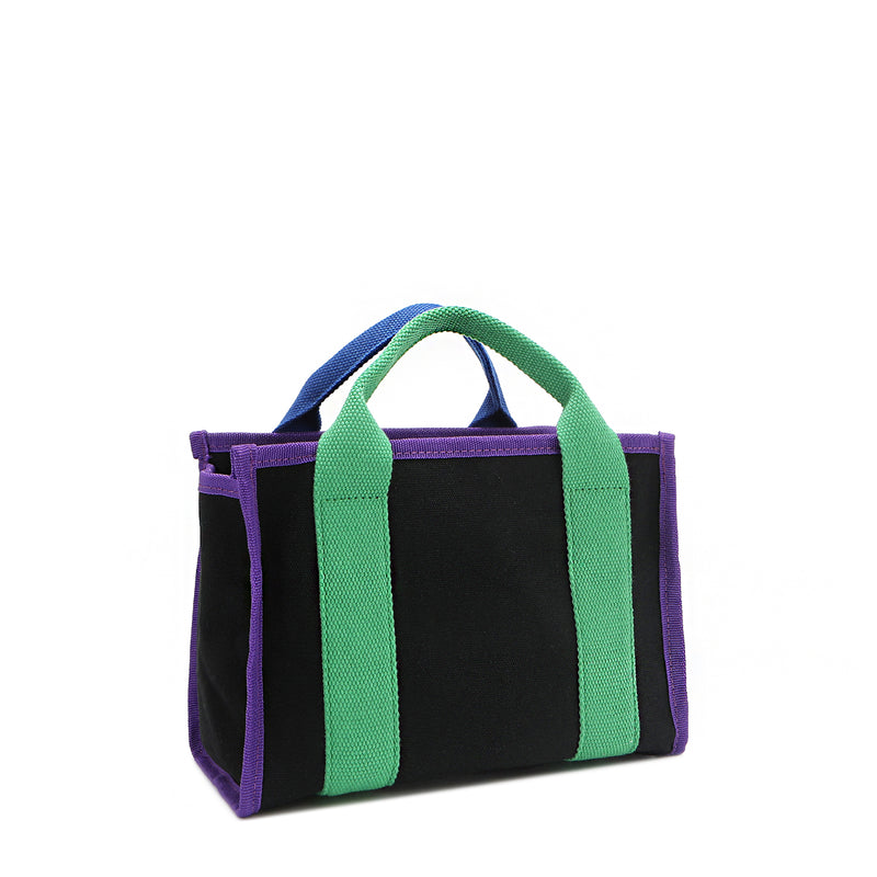 Back angle of the Rowan Nodu Nadu by Nicole Lee handbag with green and purple trim and strap accents. Made of sturdy, lightweight, and durable canvas/polyester and designed to compliment any look, from day to night, regardless of the season!
