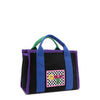 Front angle of the small Rowan polyester bag with bold color-block trim and mix-and-match straps—because your style deserves options! Available in classic black with bold blue and purple accents and a checker print smiley face adorned embroidered logo patch on the front. 