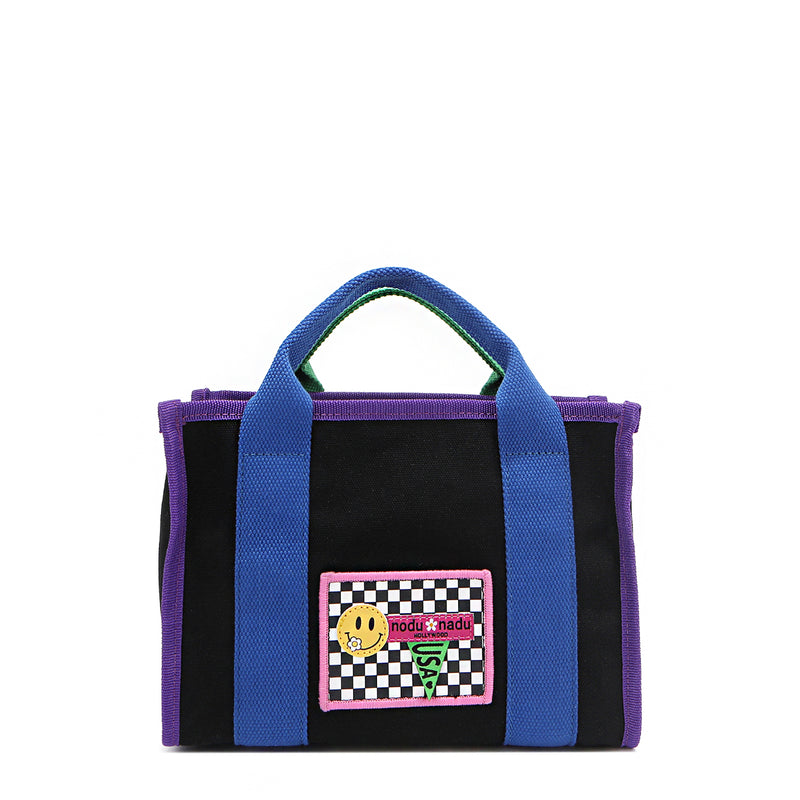 Why settle for one color when you can have them all? The small Rowan polyester bag brings the fun with bold color-block trim and mix-and-match straps—because your style deserves options! Available in classic black with bold blue and purple accents and a checker print smiley face adorned embroidered logo patch on the front. 