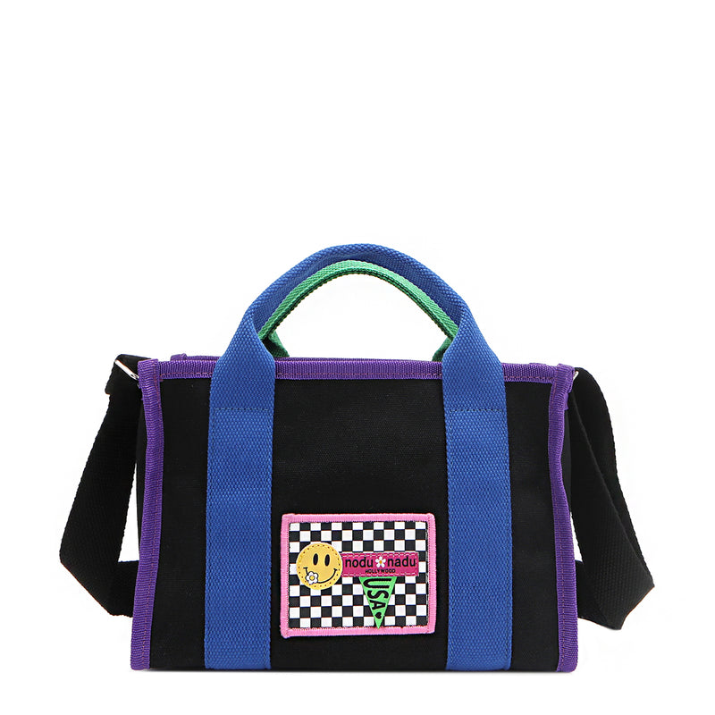 The Rowan bag by Nodu Nadu by Nicole Lee. A bold mix of colors like vivid green, electric blue and vibrant purple trim evoke a sense of fun and lots of personality to mix and match your style. Dual top handles with a 3" drop allow you to carry this statement bag by the top handles or wear it across the body thanks to the optional, adjustable black shoulder strap! 
