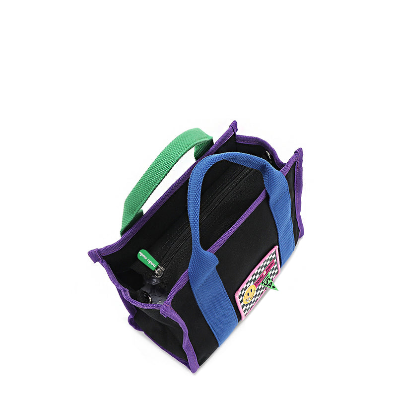 Top angle of the Rowan handbag by Nodu Nadu in timeless black. Bold pops of color like electric blue, grass green, and royal purple add lots of fun and personality to this classic shaped silhouette handbag. Comes with a secure main zip closure with matching tonal green zipper puller. 