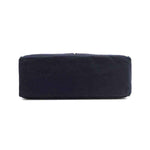 Solid navy blue base of the Emery tote bag from Nodu Nadu by Nicole Lee. Rectangular, slim and classic base. 