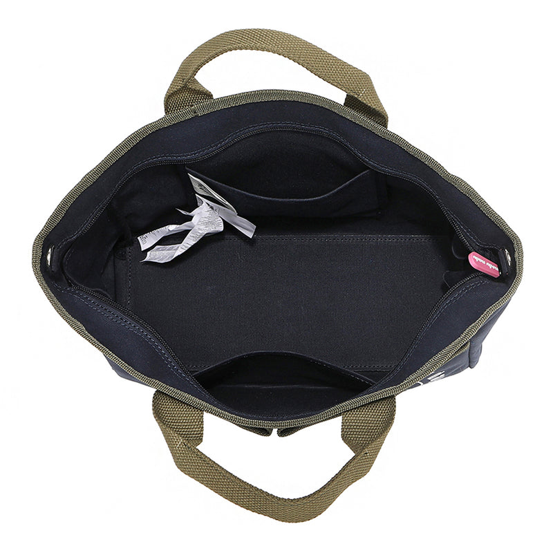 Emery Nodu Nadu tote bag in navy blue zips open thanks to the main recessed zip top closure and features interior back and front slip pockets along with side slip pockets to securely hold bottles and keep them upright to avoid spills! Side D-rings for optional shoulder strap attachment. Sturdy base to keep items secure during transit. 