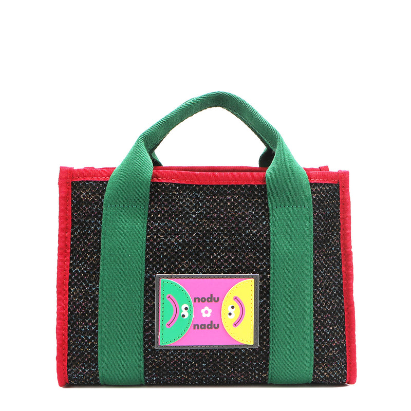 With its effortless slouchy silhouette and striking color-block trim, the Nodu Nadu small Marley tote in Black is anything but ordinary. The real showstopper? Its canvas fabric, woven with rainbow metallic stitching that catches the light just right—adding a dreamy shimmer and a touch of everyday magic to your look!