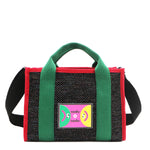 Front view of Nodu Nadu Marley Bag in black with optional, adjustable and detachable black wide shoulder strap attached to show varied carrying options. Wear this rectangular tote by the top handles or around the shoulder or across the body!