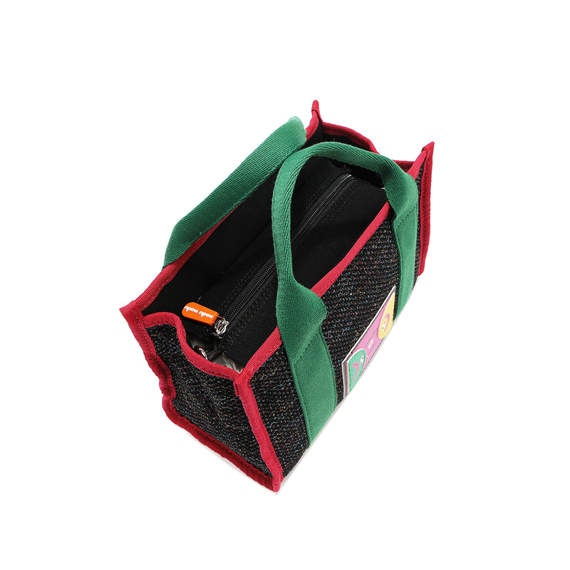 Top angle of the Nodu Nadu Marley Bag in black with green dual top handles. Main zip top closure zips open to reveal a roomy interior for your everyday essentials. 