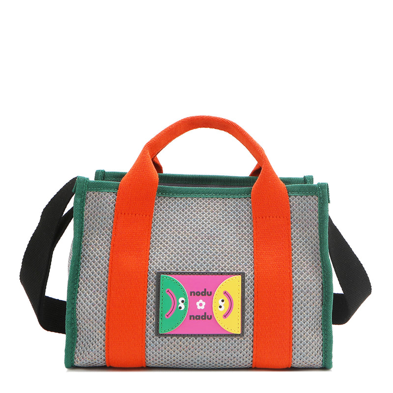 Front view of Nodu Nadu Marley Bag in Gray with optional, adjustable and detachable black wide shoulder strap attached to show varied carrying options. Wear this rectangular tote by the top handles or around the shoulder or across the body!