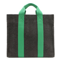 Back of the Nodu Nadu Sawyer Bag in Black. Charcoal black canvas accented with bold grass green straps for a pop of trendy color and vibrance. Rectangular silhouette provides a sense of classic timelessness so you can dress up or dress down this everyday style. 