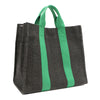 Back angle view of the Nodu Nadu Sawyer Bag in Black with grass green accents. Rectangular side view of the canvas bag shows the side slip pocket that can store any essentials you want close at hand. 