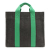 Back of the Nodu Nadu Sawyer Bag in Black. Charcoal black canvas accented with bold grass green straps for a pop of trendy color and vibrance. Rectangular silhouette provides a sense of classic timelessness so you can dress up or dress down this everyday style. 
