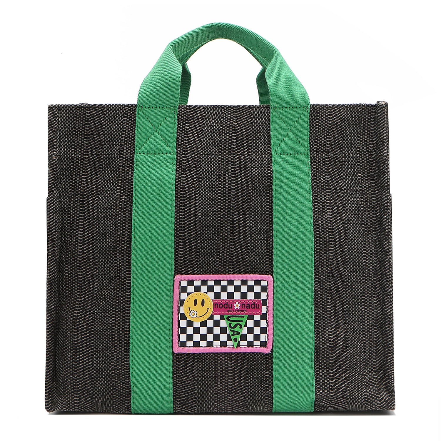 Your must-have carryall for school, weekends, and everything in between! Designed with a soft, relaxed silhouette, the Nodu Nadu Sawyer in Black offers plenty of space to keep notebooks and loose essentials effortlessly organized—so you're always ready to grab and go! Charcoal Black canvas paired with grass green strap accents. 