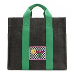 Your must-have carryall for school, weekends, and everything in between! Designed with a soft, relaxed silhouette, the Nodu Nadu Sawyer in Black offers plenty of space to keep notebooks and loose essentials effortlessly organized—so you're always ready to grab and go! Charcoal Black canvas paired with grass green strap accents. 