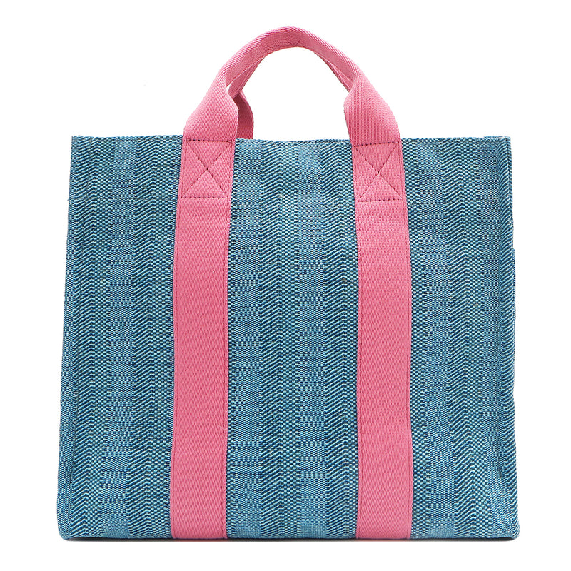 Back view of the Nodu Nadu Sawyer Bag in Blue with baby pink strap accents. Durable, canvas material in a rectangular silhouette offers endless expression to mix and match your style no matter the season or occasion. 