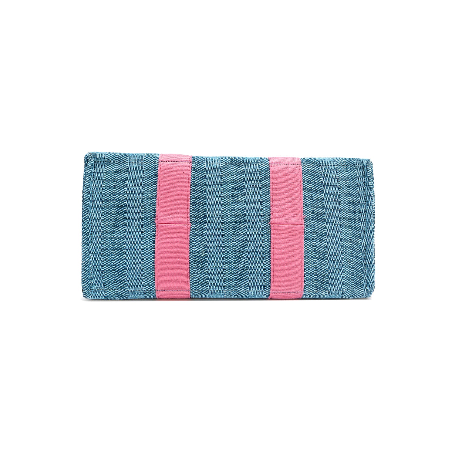 Rectangular bottom angle of the Nodu Nadu Sawyer Bag in Blue with baby pink webbed strap details. Made of durable canvas for long-lasting style.