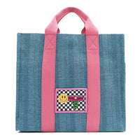 Your must-have carryall for school, weekends, and everything in between! Designed with a soft, relaxed silhouette, the Nodu Nadu Sawyer in Blue offers plenty of space to keep notebooks and loose essentials effortlessly organized—so you're always ready to grab and go! Light blue canvas paired with baby pink strap accents. 