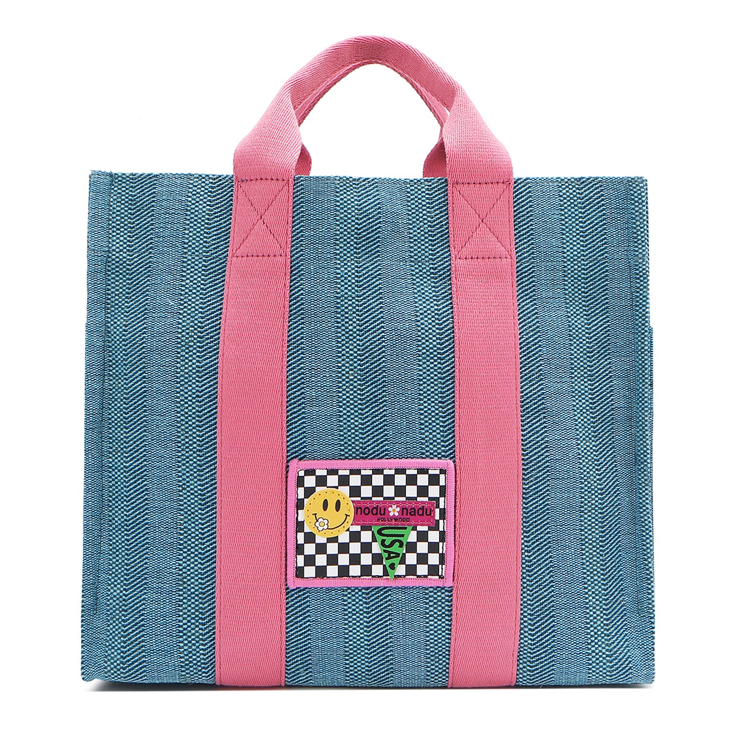 Your must-have carryall for school, weekends, and everything in between! Designed with a soft, relaxed silhouette, the Nodu Nadu Sawyer in Blue offers plenty of space to keep notebooks and loose essentials effortlessly organized—so you're always ready to grab and go! Light blue canvas paired with baby pink strap accents. 