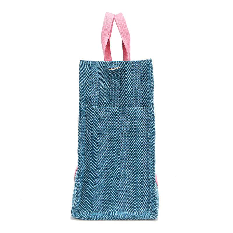 Rectangular side profile of the Nodu Nadu Sawyer Bag in Blue. Crafted in durable canvas with side D-rings for optional shoulder strap attachment so you can wear this bag as a handbag, shoulder bag, or crossbody! It also features side slip pockets for a convenient touch. 