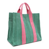 Back angle view of the Nodu Nadu Sawyer Bag in Green with baby pink accents. Rectangular side view of the canvas bag shows the side slip pocket that can store any essentials you want close at hand. 
