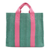 Back of the Nodu Nadu Sawyer Bag in Green. Light green canvas accented with baby pink straps for a pop of trendy color and femininity. Rectangular silhouette provides a sense of classic timelessness so you can dress up or dress down this everyday style. 