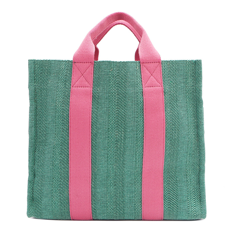 Back of the Nodu Nadu Sawyer Bag in Green. Light green canvas accented with baby pink straps for a pop of trendy color and femininity. Rectangular silhouette provides a sense of classic timelessness so you can dress up or dress down this everyday style. 