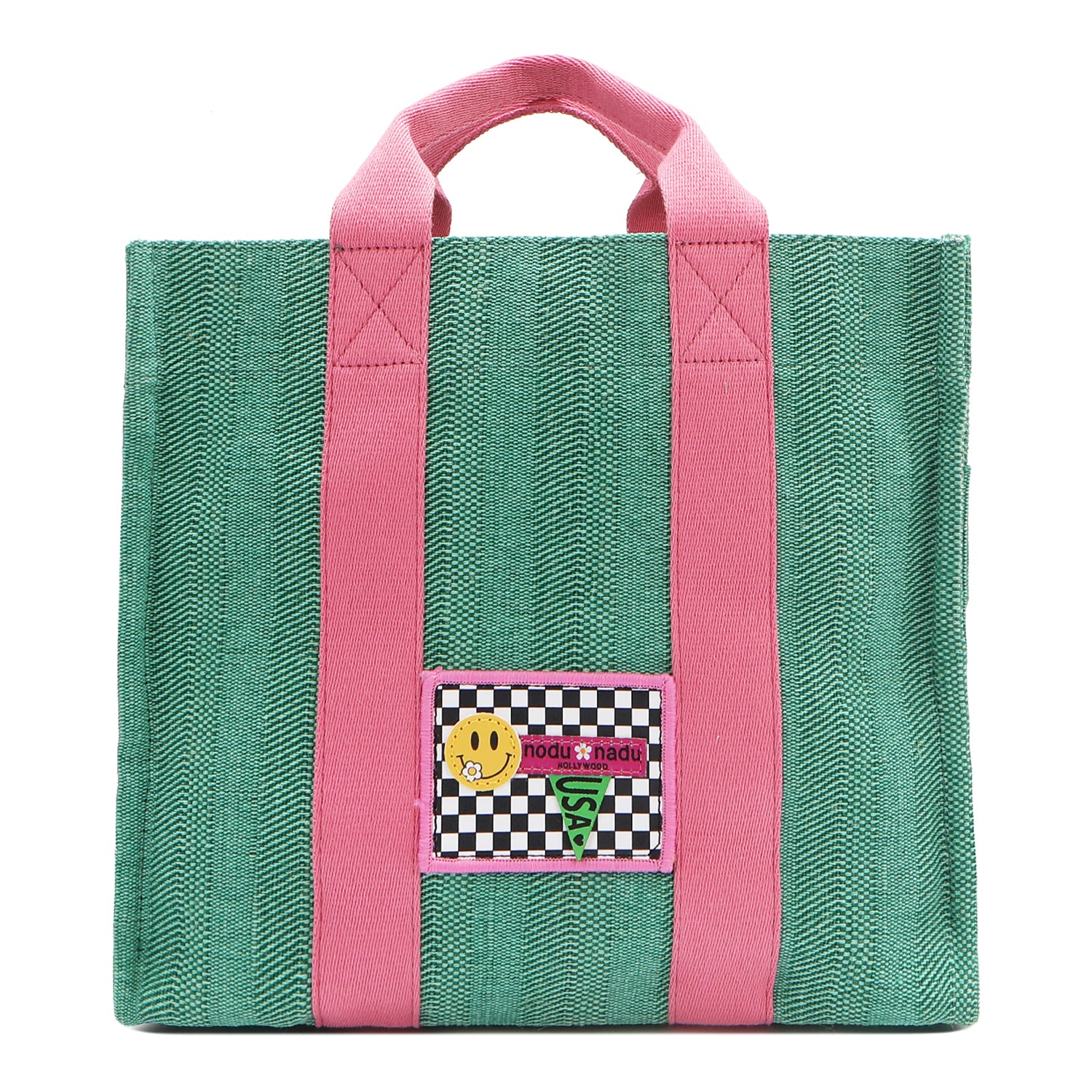 Your must-have carryall for school, weekends, and everything in between! Designed with a soft, relaxed silhouette, the Nodu Nadu Sawyer in Green offers plenty of space to keep notebooks and loose essentials effortlessly organized—so you're always ready to grab and go! Light green-colored canvas paired with baby pink strap accents. 