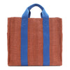 Back of the Nodu Nadu Sawyer Bag in Orange. Orange/sienna brown-colored canvas accented with bold electric blue straps for a pop of trendy color and vibrance. Rectangular silhouette provides a sense of classic timelessness so you can dress up or dress down this everyday style. 