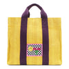 Your must-have carryall for school, weekends, and everything in between! Designed with a soft, relaxed silhouette, the Nodu Nadu Sawyer in Yellow offers plenty of space to keep notebooks and loose essentials effortlessly organized—so you're always ready to grab and go! Sunny yellow canvas paired with eggplant purple strap accents. 